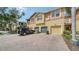 Inviting townhome with brick driveway, attached garage, and lush landscaping at 7983 Limestone Ln # 14-201, Sarasota, FL 34233