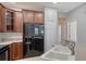 Well-lit kitchen featuring wood cabinets, modern appliances, and a functional double sink at 7983 Limestone Ln # 14-201, Sarasota, FL 34233