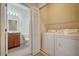 A laundry room and bathroom with modern appliances at 7983 Limestone Ln # 14-201, Sarasota, FL 34233