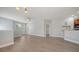 Spacious living area, featuring wood floors, large windows, and seamless flow to kitchen at 7983 Limestone Ln # 14-201, Sarasota, FL 34233