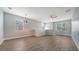 Open living space filled with natural light, featuring wood floors and a ceiling fan at 7983 Limestone Ln # 14-201, Sarasota, FL 34233