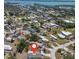 Aerial view of a dense residential area with lush greenery and nearby waterway access at 8225 Drew St, Englewood, FL 34224