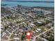 High-angle aerial shot showcasing a community of houses by the water with a mix of residential streets and nature at 8225 Drew St, Englewood, FL 34224