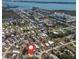 Aerial view of a residential neighborhood with waterfront access, featuring a nearby bay at 8225 Drew St, Englewood, FL 34224