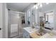 Bright bathroom with a glass enclosed shower, dual sinks, and a decorative beach theme at 8225 Drew St, Englewood, FL 34224