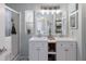 Charming bathroom with double sinks, wood countertops, and decorative nautical details at 8225 Drew St, Englewood, FL 34224