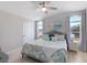 Cozy bedroom with vaulted ceilings, arched windows, ceiling fan, and beach-themed decor at 8225 Drew St, Englewood, FL 34224