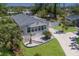 Aerial view of a well-maintained property with lush landscaping and a paved driveway at 8225 Drew St, Englewood, FL 34224