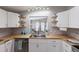 Bright kitchen featuring stainless steel appliances, butcher block countertops, and stylish shelving at 8225 Drew St, Englewood, FL 34224
