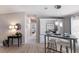 Open living area featuring modern furnishings, wood-look floors, and a peek into the bedroom at 8225 Drew St, Englewood, FL 34224