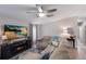 Comfortable living room featuring an electric fireplace, sectional sofa with accent pillows, and modern decor at 8225 Drew St, Englewood, FL 34224