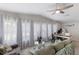 Spacious living room features bright windows, ceiling fan, and comfortable seating area at 8225 Drew St, Englewood, FL 34224