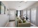 Bright living room with modern decor, plush seating, and abundant natural light from large windows at 8225 Drew St, Englewood, FL 34224
