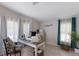 Well-lit home office space featuring a large desk, ample storage, and comfortable seating with stylish decor at 8225 Drew St, Englewood, FL 34224