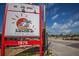 The SandBar Tiki & Grille advertises under sunny skies with palm trees in the background at 8225 Drew St, Englewood, FL 34224
