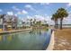 Scenic view of a waterfront restaurant with outdoor seating along a canal with kayakers at 8225 Drew St, Englewood, FL 34224