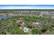 Beautiful acreage estate featuring a serene pool, mature trees, and lush greenery at 8280 Ibis St, Sarasota, FL 34241