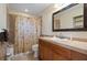 Standard bathroom with tiled shower and tub, laminate countertop, and neutral walls at 8280 Ibis St, Sarasota, FL 34241
