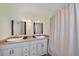 Bathroom featuring double sinks with plenty of counter space and a shower and tub at 8280 Ibis St, Sarasota, FL 34241
