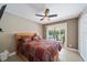 This bedroom features an exterior door to the pool and has an overhead ceiling fan at 8280 Ibis St, Sarasota, FL 34241
