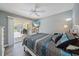 A comfortable bedroom has neutral paint, patio access, and a TV for relaxing at 8280 Ibis St, Sarasota, FL 34241