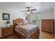 Bedroom with a window, hardwood flooring, ceiling fan, and a neutral color scheme at 8280 Ibis St, Sarasota, FL 34241