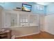 Upstairs bonus room with blue walls, hardwood floors, and a small window offering natural light at 8280 Ibis St, Sarasota, FL 34241