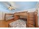 Bedroom featuring built-in bunk beds, wood floors, and a ceiling fan at 8280 Ibis St, Sarasota, FL 34241
