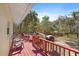 Scenic deck offering ample seating and a glimpse of the beautiful horse pasture and wooded surroundings at 8280 Ibis St, Sarasota, FL 34241