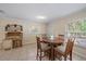 Cozy dining area featuring natural light from the window, a wood table, and a built-in desk near the exit at 8280 Ibis St, Sarasota, FL 34241