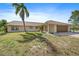 Inviting single-story home featuring an attached garage and lush lawn at 8280 Ibis St, Sarasota, FL 34241