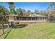 Home exterior featuring a large screened-in porch and spacious yard at 8280 Ibis St, Sarasota, FL 34241
