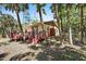 Home exterior featuring a wooden deck surrounded by trees and landscaping at 8280 Ibis St, Sarasota, FL 34241