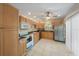 Well-lit kitchen with light wood cabinets, granite countertops, and stainless steel refrigerator at 8280 Ibis St, Sarasota, FL 34241