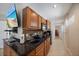 Efficient kitchen area features dark countertop and wood cabinetry at 8280 Ibis St, Sarasota, FL 34241