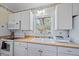 Cozy kitchen with white appliances, butcher block countertops, and a view from the window at 8280 Ibis St, Sarasota, FL 34241