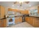 Traditional-style kitchen with light wood cabinets, granite countertops, and modern appliances at 8280 Ibis St, Sarasota, FL 34241