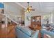 Bright living area with hardwood floors, staircase, and cozy seating arrangement at 8280 Ibis St, Sarasota, FL 34241