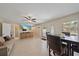 Open-concept living area features tile flooring, ceiling fan, and comfortable seating with access to a small kitchenette at 8280 Ibis St, Sarasota, FL 34241