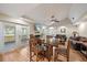Open concept living area features a dining table, fireplace, wood floors, and access to a porch at 8280 Ibis St, Sarasota, FL 34241