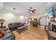 Open concept living and dining area with wood floors, ceiling fan, and natural light at 8280 Ibis St, Sarasota, FL 34241