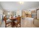 Bright living room with tiled floors, wood table, and natural light flowing into the adjacent kitchen area at 8280 Ibis St, Sarasota, FL 34241