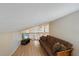 Cozy loft area featuring a comfortable sofa, mounted TV, and wooden floors at 8280 Ibis St, Sarasota, FL 34241