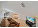 Relaxing loft space with a sofa, TV, laminate flooring, and ample natural light at 8280 Ibis St, Sarasota, FL 34241