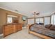 An expansive main bedroom features a dresser, closet, ceiling fan, and sitting area at 8280 Ibis St, Sarasota, FL 34241