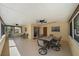 Covered patio featuring a dining table set and ceiling fans for outdoor entertaining at 8280 Ibis St, Sarasota, FL 34241
