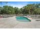 Backyard pool surrounded by a white fence and featuring ample lounge space at 8280 Ibis St, Sarasota, FL 34241