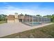 Back of house featuring a large screened-in pool and outdoor living space on a sunny day at 8280 Ibis St, Sarasota, FL 34241