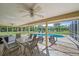A screened-in patio overlooks the pool, offering space for outdoor dining and relaxing at 8280 Ibis St, Sarasota, FL 34241