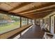 Covered screened-in porch with wood floors, a wood ceiling, and views of the backyard at 8280 Ibis St, Sarasota, FL 34241